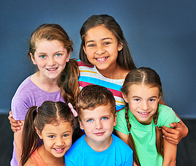 Buy stock photo Studio shot of a diverse group of kids posing together against a blue background