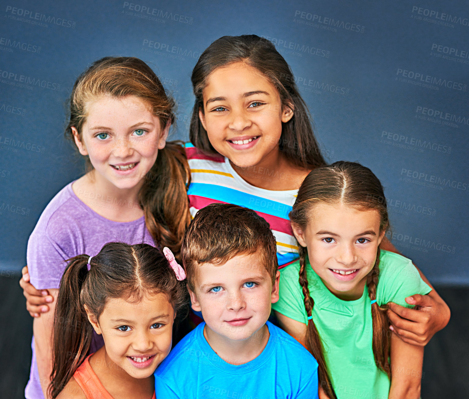 Buy stock photo Studio shot of a diverse group of kids posing together against a blue background