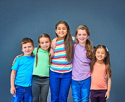 Buy stock photo Hug, happy and portrait of children on blue background for back to school, education and academy. Students, friends and group of kids with smile for learning, scholarship and diversity in studio