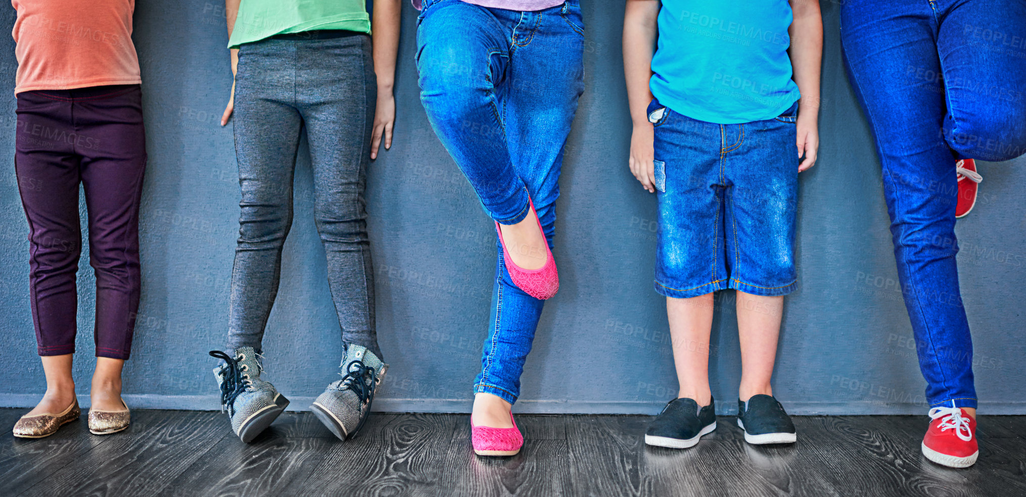 Buy stock photo Cropped studio shot of a group of kids standing against a blue wall