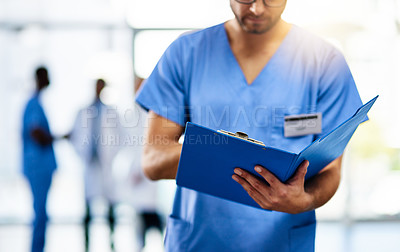 Buy stock photo Doctor, medical professional and worker reading from a file, folder or form while working at a modern hospital. Nurse, surgeon or gp analyzing research, insurance or diagnosis paperwork. 
