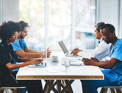 Buy stock photo Shot of a team of doctors having a meeting in a hospital