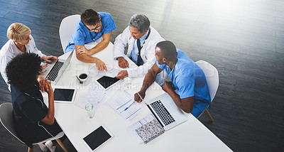 Buy stock photo Team of medical workers sitting and meeting with laptops around table. Doctors and staff discussing papers and test results. Healthcare experts handling daily tasks and duties