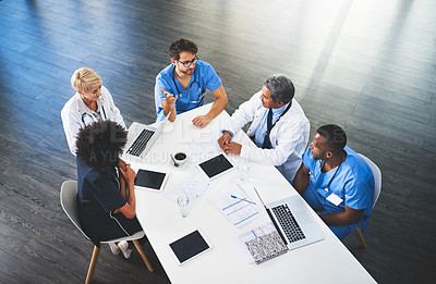 Buy stock photo Doctors, medical professionals and workers talking in a meeting, discussing a strategy and making plans while working at hospital. Clinic employees having discussion in seminar, workshop or training