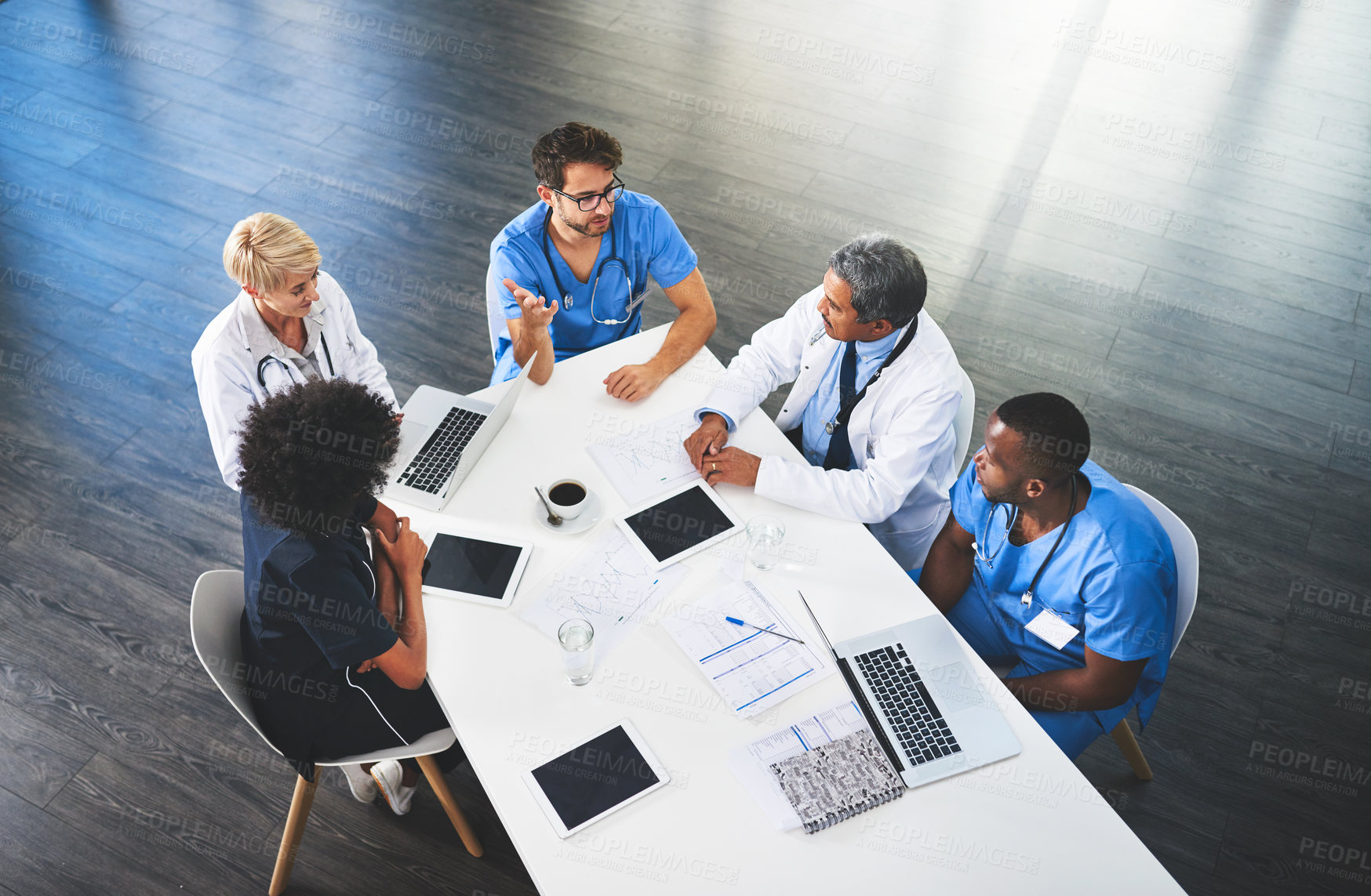 Buy stock photo Doctors, medical professionals and workers talking in a meeting, discussing a strategy and making plans while working at hospital. Clinic employees having discussion in seminar, workshop or training