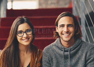 Buy stock photo Cropped portrait of two young university students studying while sitting on a staircase on campus