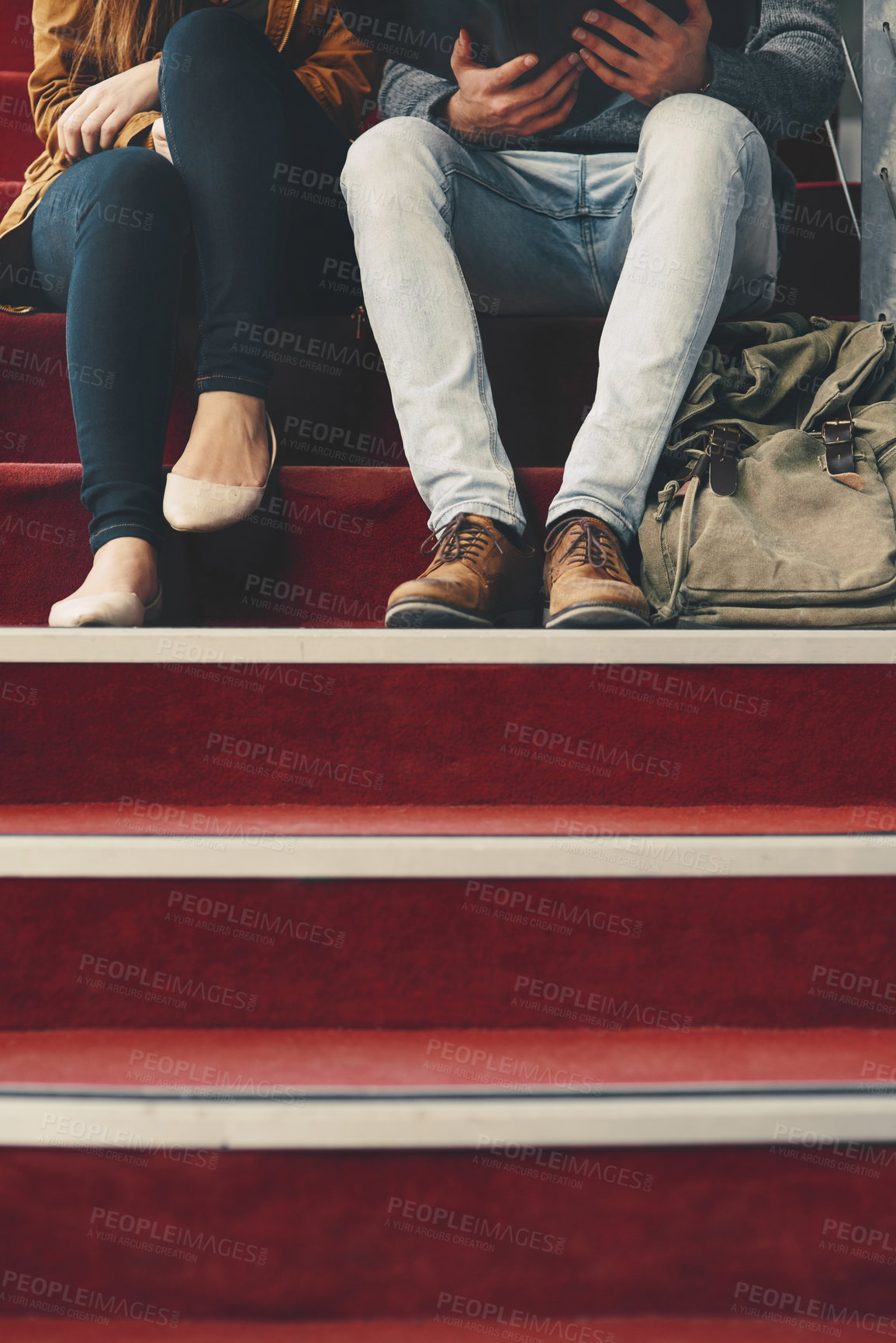 Buy stock photo Cropped shot of two unrecognizable university students studying while sitting on a staircase on campus