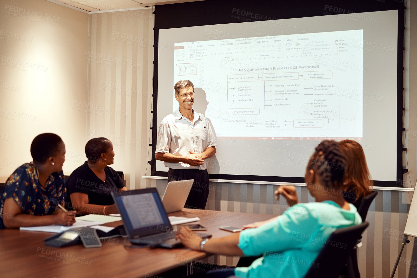 Buy stock photo Shot of colleagues having a meeting in a modern office