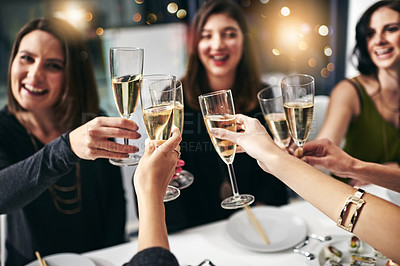 Buy stock photo Cropped shot of a group of young girlfriends toasting during a dinner party at a restaurant