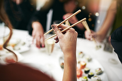 Buy stock photo Chopstick, dinner party and woman hand at a restaurant at a table with drinks. Asian meal, sushi and friends celebration event with food and social group with drink together at a Japanese dining bar