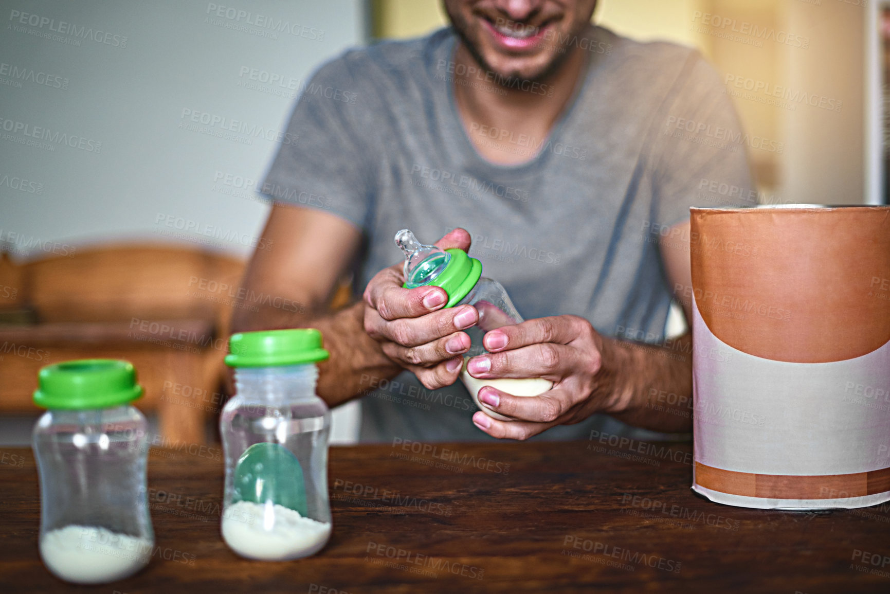 Buy stock photo Father, hands and milk with baby bottle for formula, nutrition or vitamins for young child or kid. Closeup, dad and meal prep with drink, container or powder for calcium, development or early growth