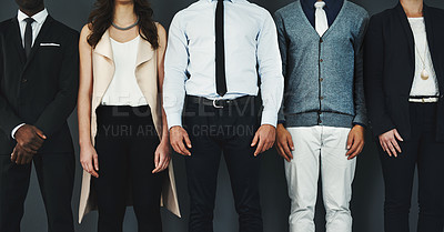 Buy stock photo Studio shot of an unrecognisable group of businesspeople standing against a grey background