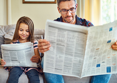 Buy stock photo Happy father, daughter and reading newspaper on sofa for knowledge, literature or news in living room at home. Dad, child and smile for family bonding, learning or education on lounge couch together