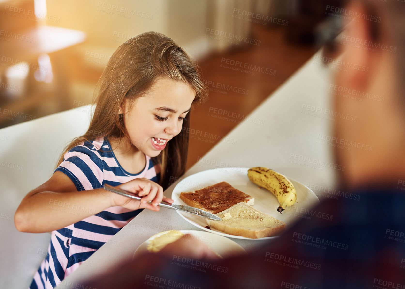 Buy stock photo Cropped shot of an adorable little girl having breakfast with her father in the kitchen