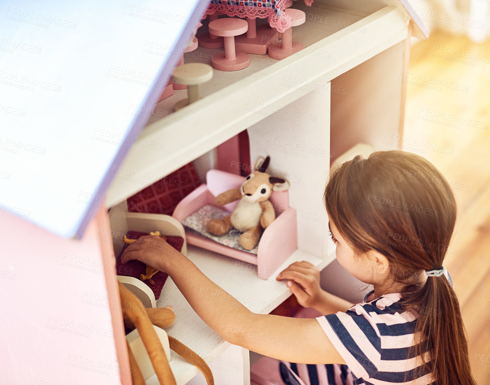 Buy stock photo Girl, dollhouse and toys in home for game, fantasy play and fun activity with teddy bears. Child, creativity and imagination in bedroom with dolls, story development and growth with inspiration