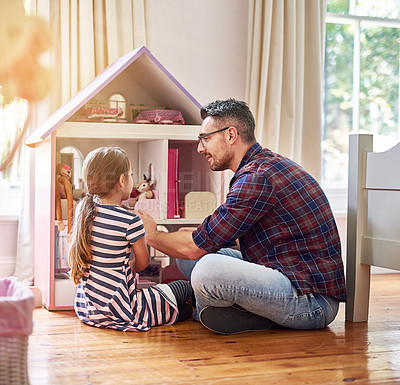 Buy stock photo Rearview shot of a little girl and her father playing with a dollhouse while sitting on the bedroom floor