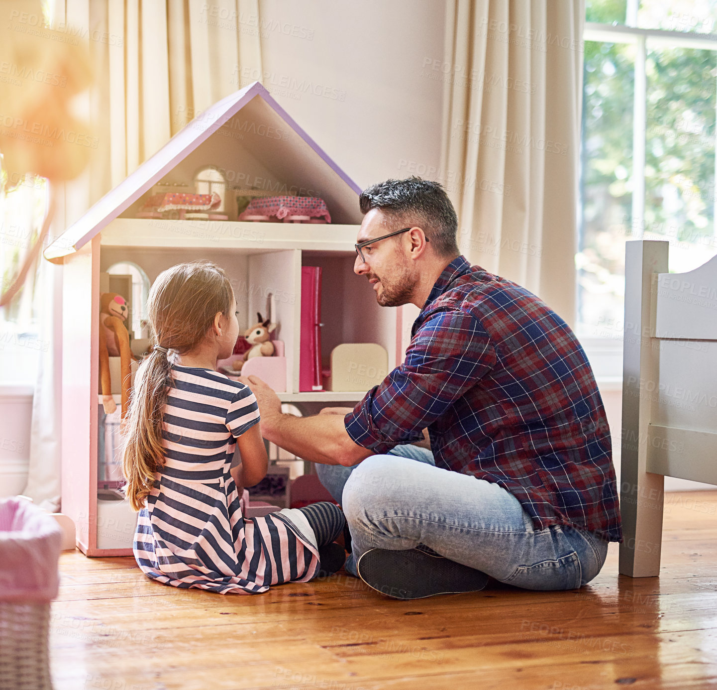 Buy stock photo Dollhouse, father and daughter play game with imagination and learning or teaching social skills on floor. Man, family and child back with tiny furniture or toys for development and bonding at home