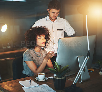 Buy stock photo Cropped shot of young employees working late into the evening