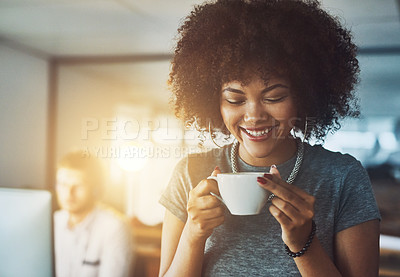 Buy stock photo Shot of a young businesswoman enjoying a cup of coffee while standing in the office