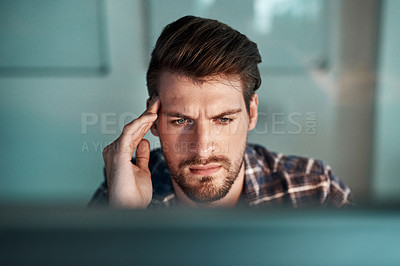 Buy stock photo Shot of a young businessman experiencing a headache at the office