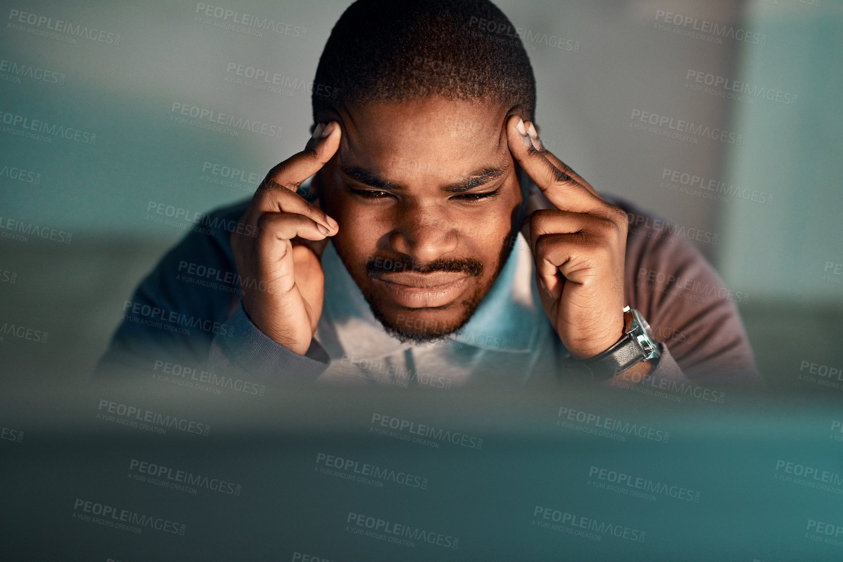 Buy stock photo Shot of a young businessman experiencing a headache at the office
