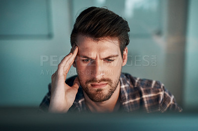 Buy stock photo Shot of a young businessman working late at the office