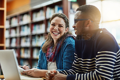 Buy stock photo Shot of two university students working together on a laptop at campus
