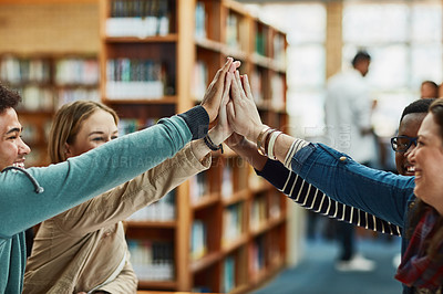 Buy stock photo Students, group and high five in library for learning, knowledge and education goals, support or team work. Young people with hands together for motivation, collaboration and success in university