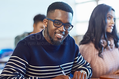 Buy stock photo Portrait of a university student working in class at campus