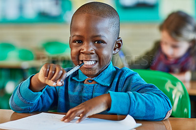 Buy stock photo Elementary school, classroom and portrait of boy with paper for learning, knowledge and assessment. Black kid, face and happy by desk with pen for child development, lesson and growth in education