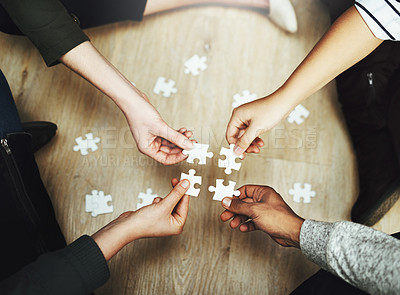 Buy stock photo Hands, business people and puzzle in circle, huddle or teamwork for problem solving, solution or game in top view. Group, together and helping with support, synergy and team building on office floor