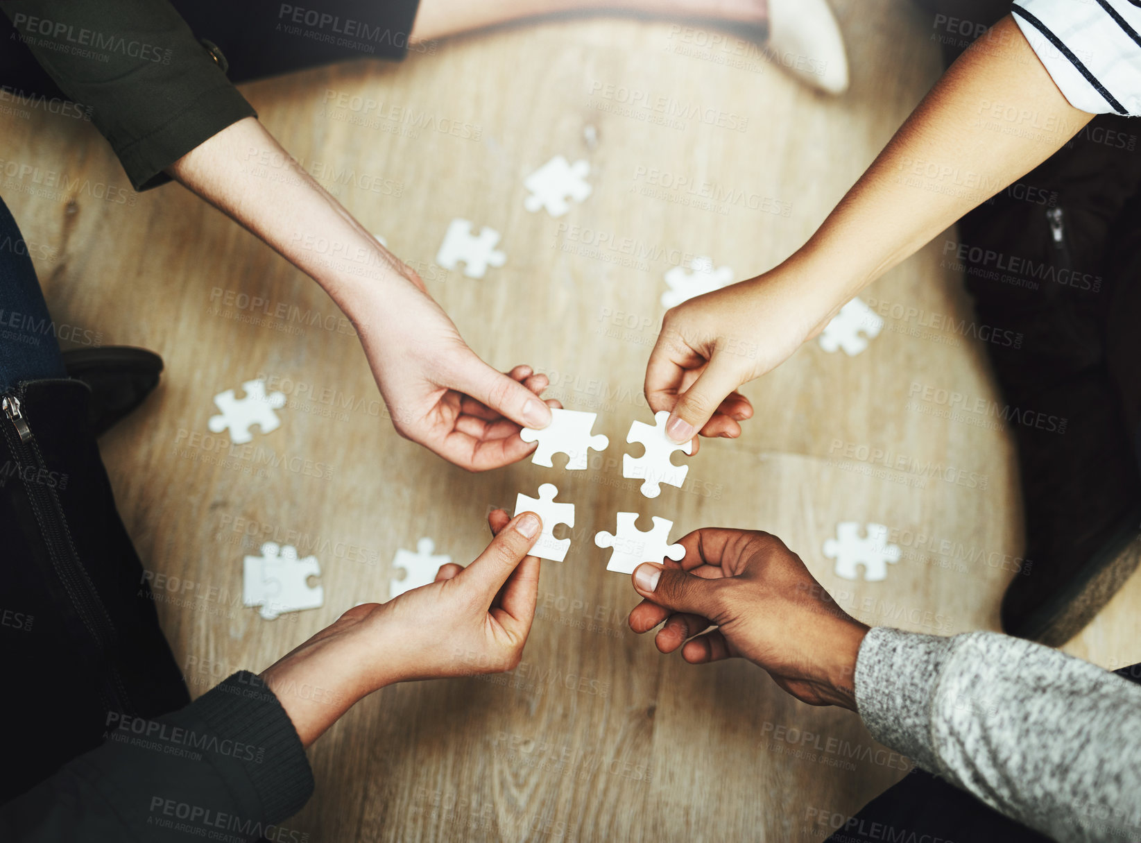 Buy stock photo Hands, business people and puzzle in circle, huddle or teamwork for problem solving, solution or game in top view. Group, together and helping with support, synergy and team building on office floor