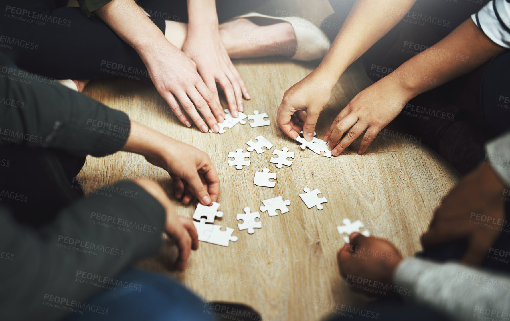 Buy stock photo People, support and hands with puzzle on table for problem solving, interaction and teamwork in integration. Diversity, team and training with jigsaw for creative strategy, collaboration and learning