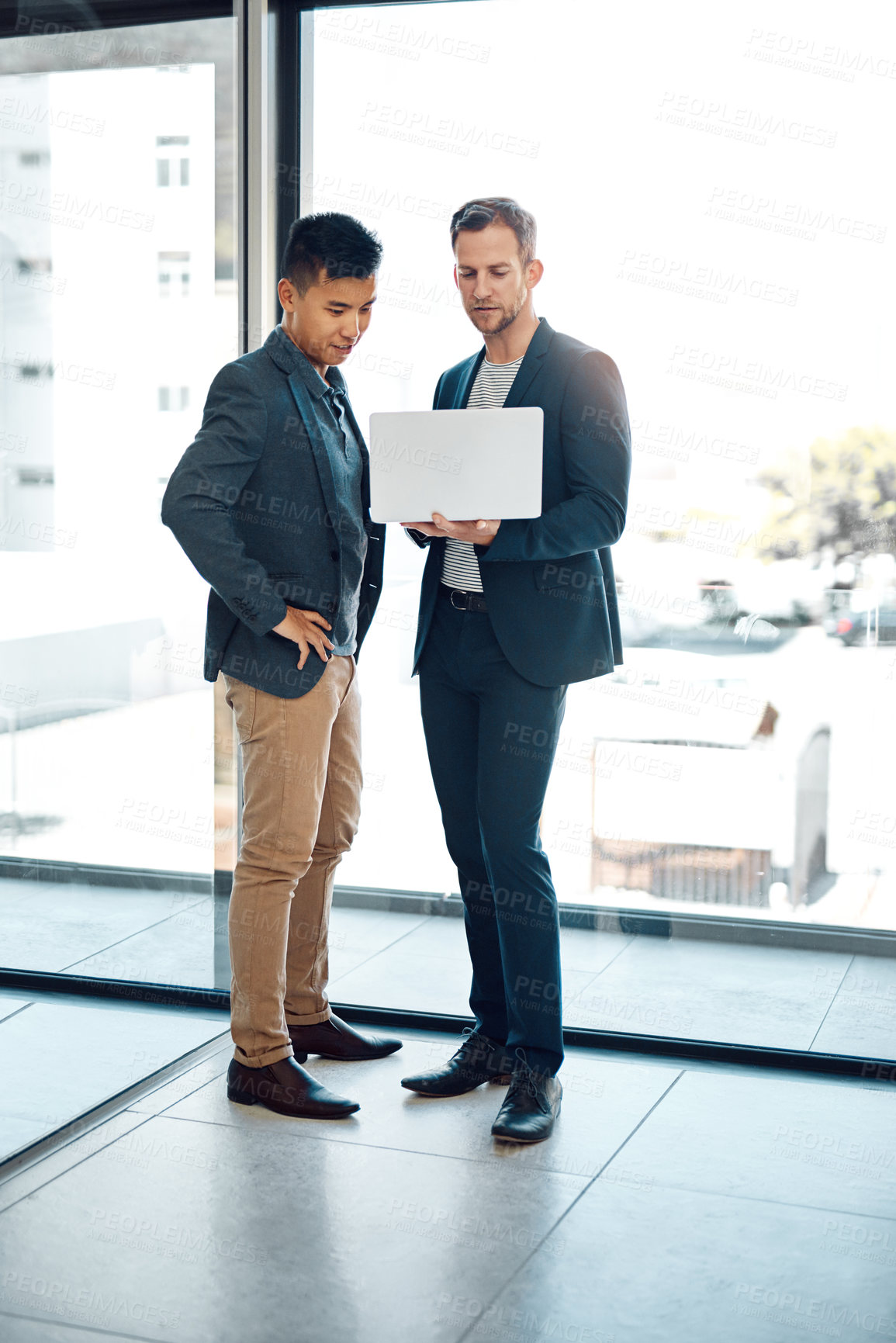 Buy stock photo Shot of colleagues using a laptop in the office