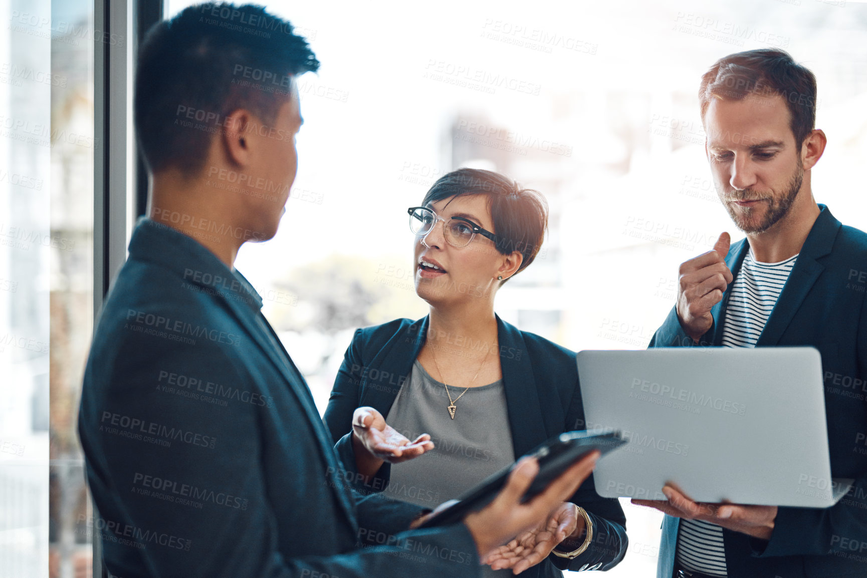 Buy stock photo Shot of colleagues using a laptop in the office