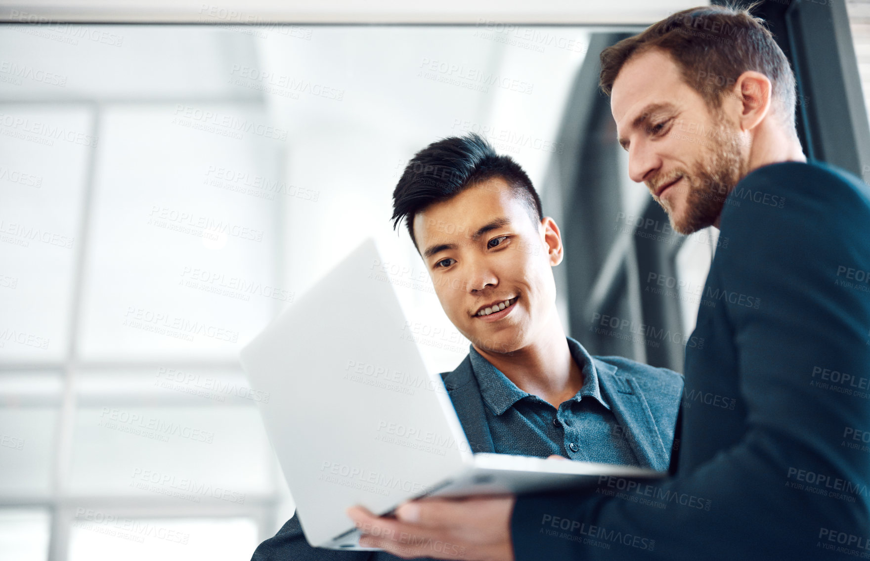 Buy stock photo Shot of colleagues using a laptop in the office