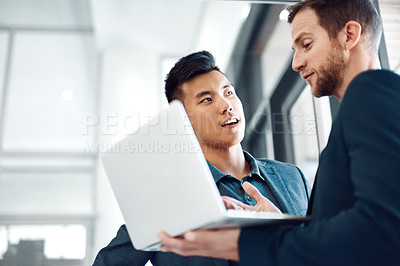 Buy stock photo Shot of colleagues using a laptop in the office