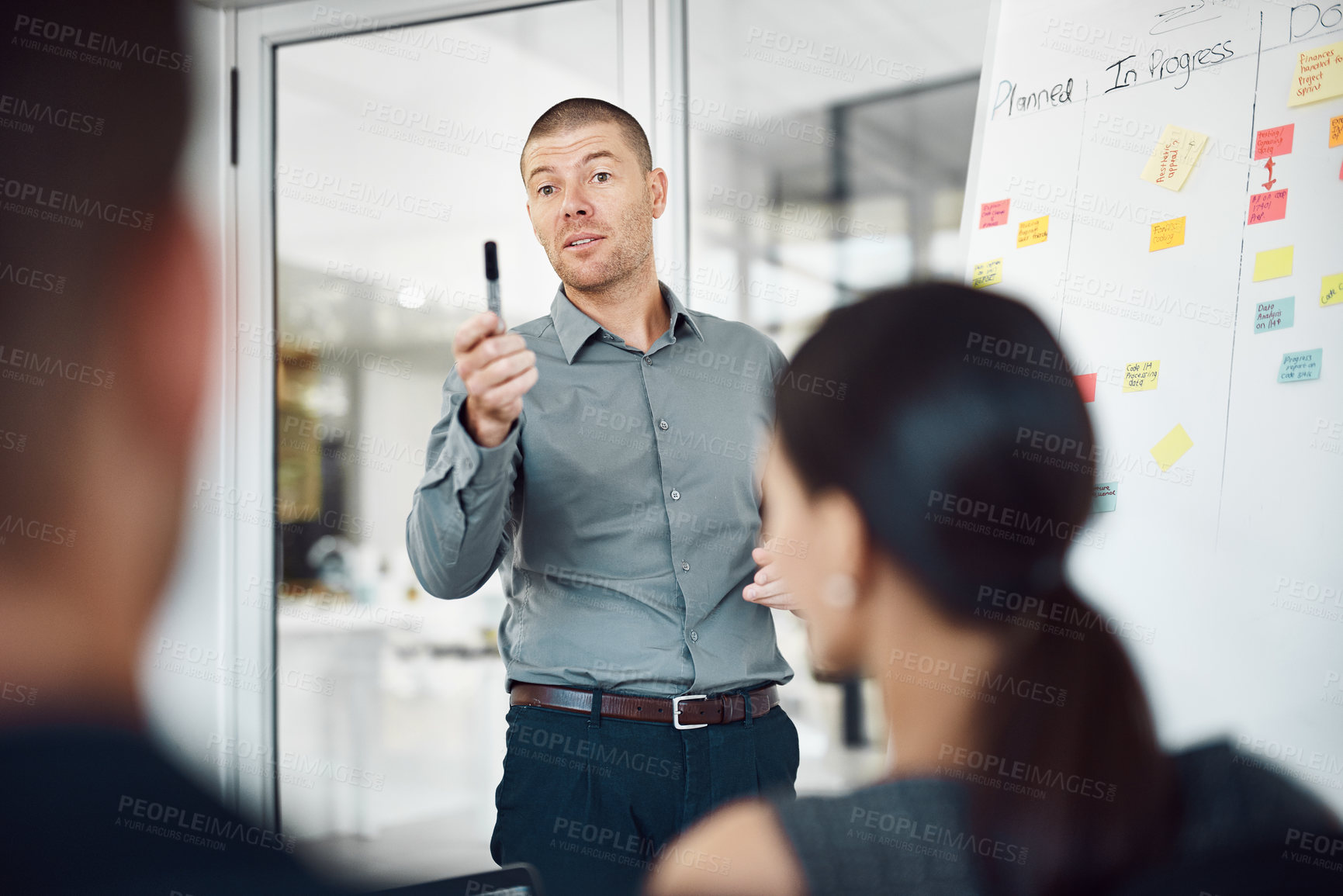 Buy stock photo Man, workshop and sticky notes on whiteboard for advice, timeline and employee engagement in office. Speaker, presentation and group training in boardroom for goals, collaboration and instruction