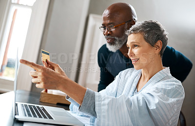 Buy stock photo Shot of a senior married couple shopping online at home