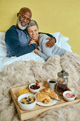 Buy stock photo Shot of a married senior couple having breakfast in bed at home