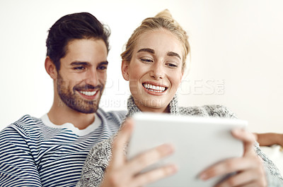 Buy stock photo Happy couple, home or tablet for movie, streaming online or news check on couch in living room in house. Technology, internet subscription and people in lounge on digital website and touchscreen app