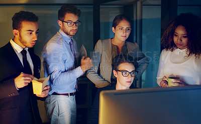 Buy stock photo Cropped shot of a diverse group of businesspeople gathered around a single computer in their office