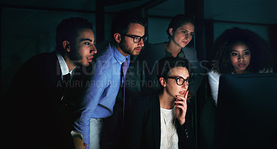 Buy stock photo Cropped shot of a diverse group of businesspeople gathered around a single computer in their office