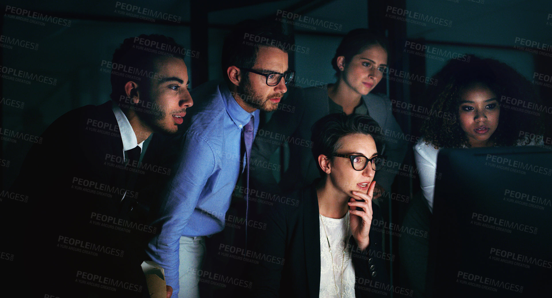 Buy stock photo Cropped shot of a diverse group of businesspeople gathered around a single computer in their office