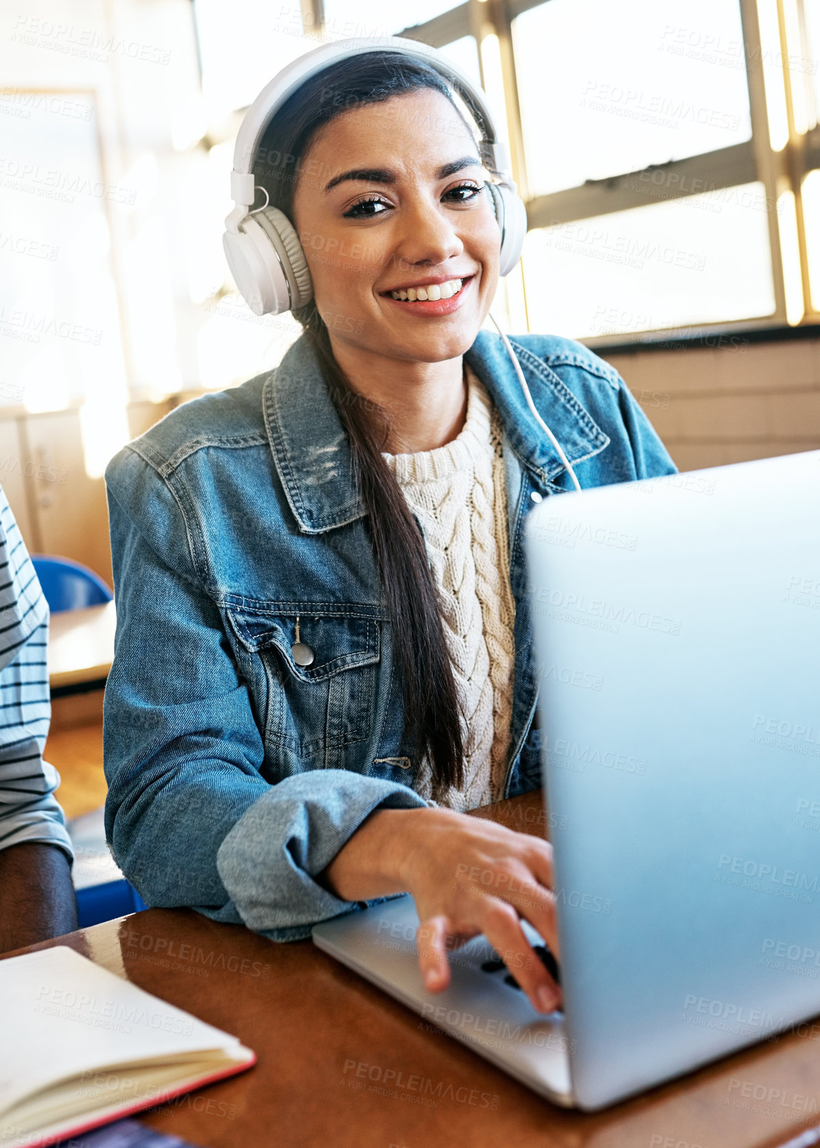 Buy stock photo Cropped portrait of an attractive young university student working on her laptop while sitting in class