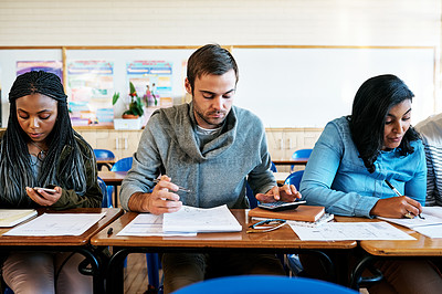 Buy stock photo Cropped shot of a group of young university students working in class