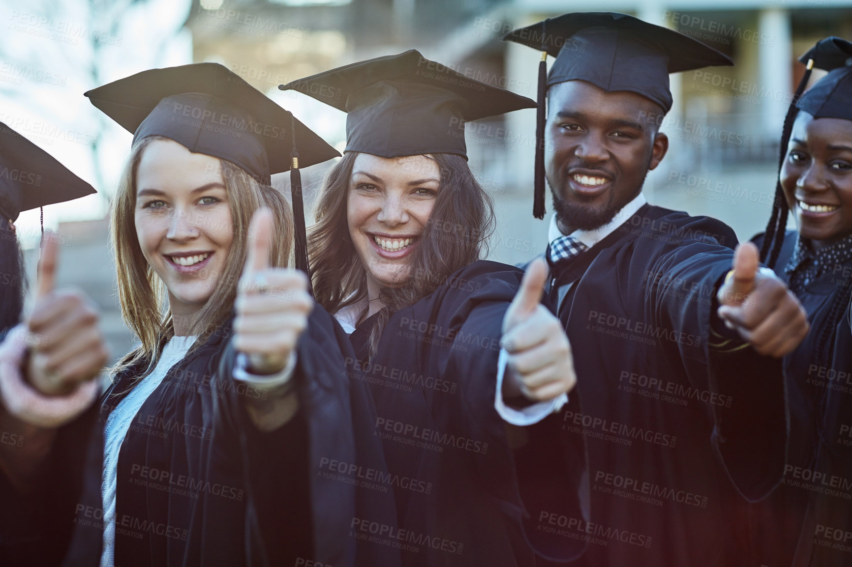 Buy stock photo Portrait of a group of students showing thumbs up on graduation day
