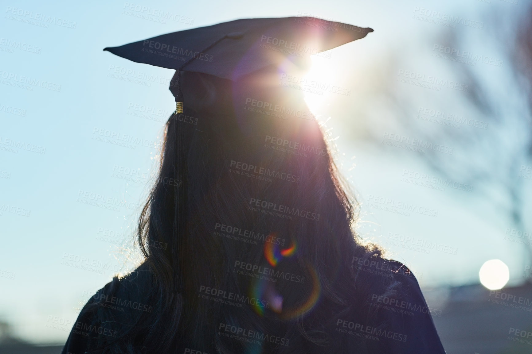 Buy stock photo Success, university and silhouette of student with graduation cap for award ceremony, achievement and education. Opportunity, campus and woman thinking at college event with lens flare from back