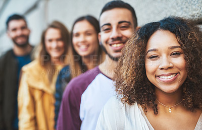 Buy stock photo Cropped shot of friends standing together while out in the city