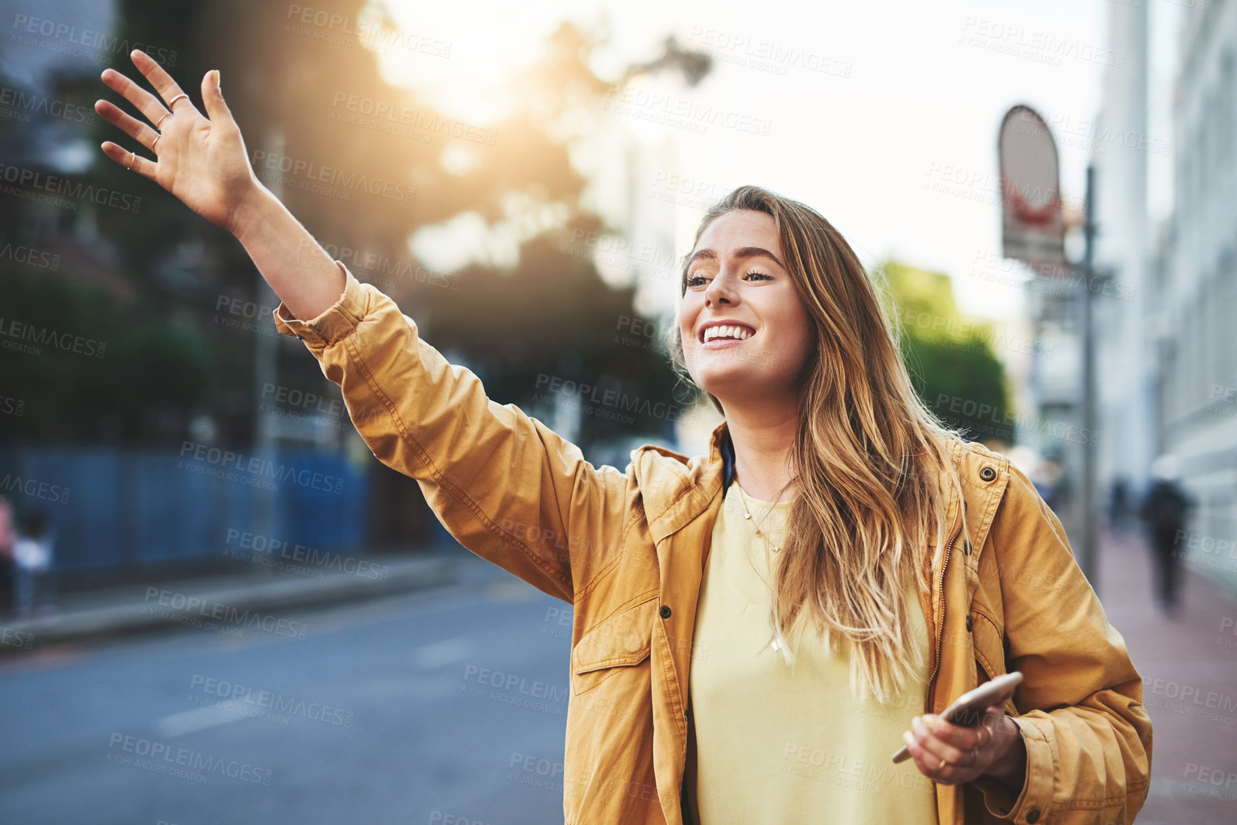 Buy stock photo Shot of an attractive woman catching a cab in the city